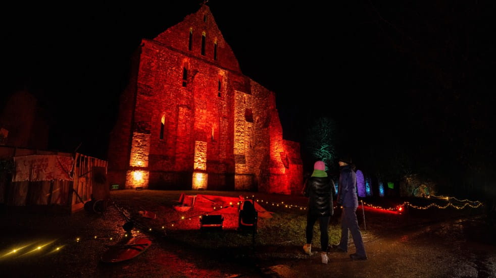 Battle Abbey lit up with red festive lights